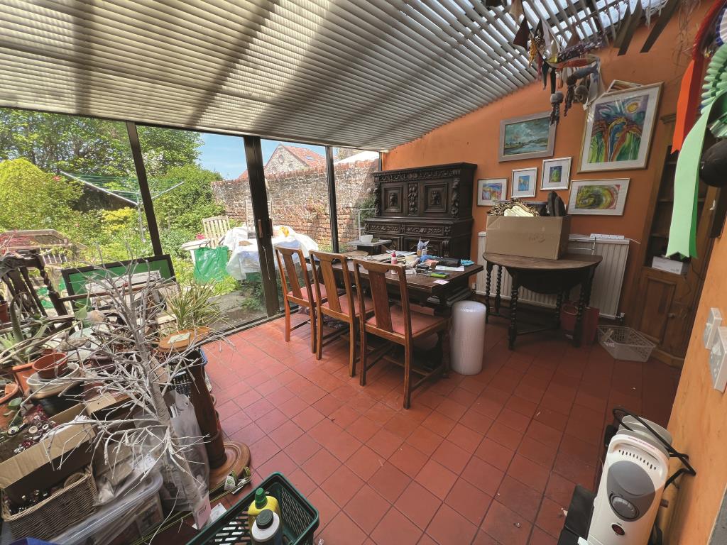 Lot: 134 - FOUR STOREY TOWN HOUSE FOR UPDATING - General view of the sunroom-conservatory looking to garden
